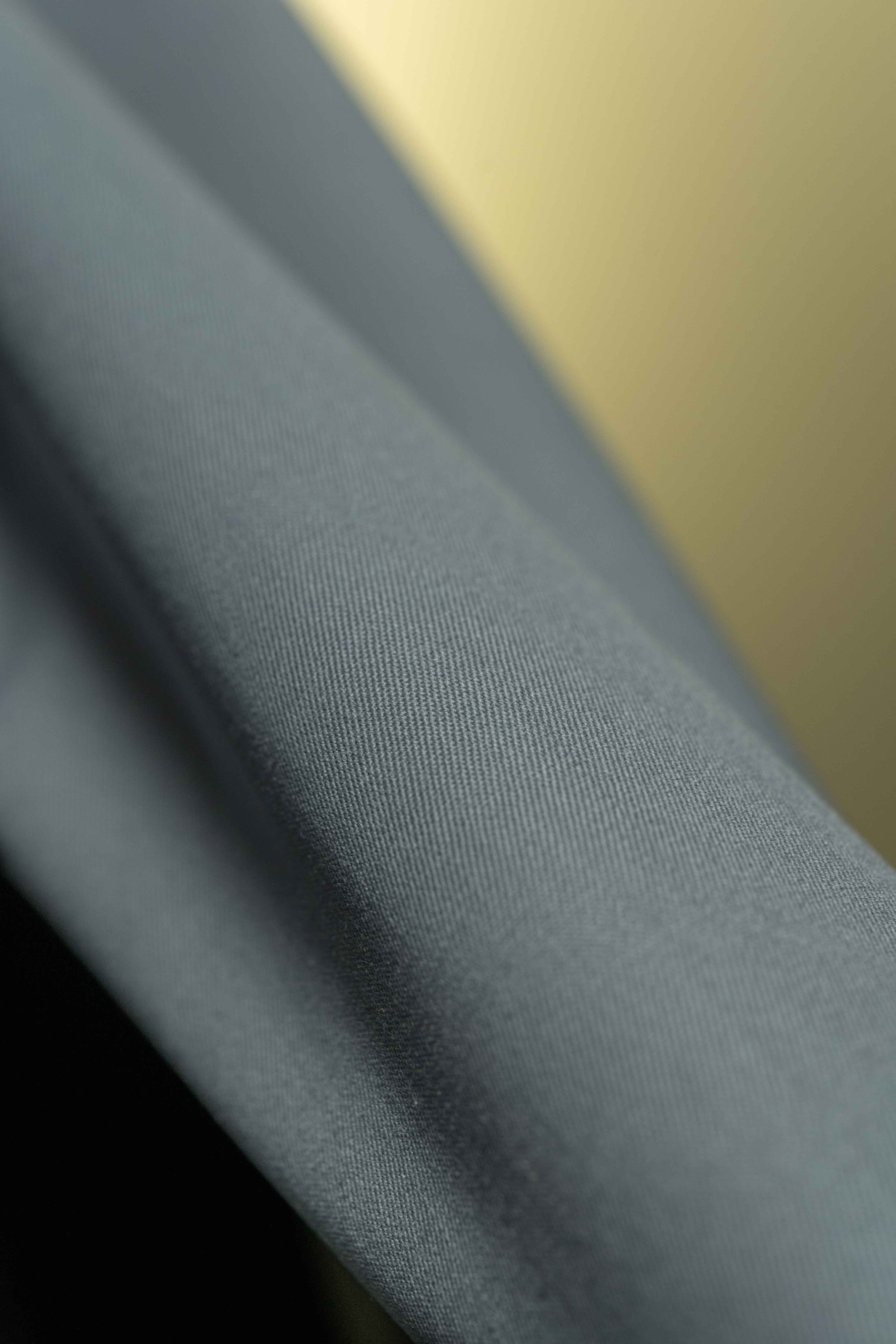 Close-up of grey 120's wool gabardine suit fabric showcasing its smooth texture and quality - 4.6m length.