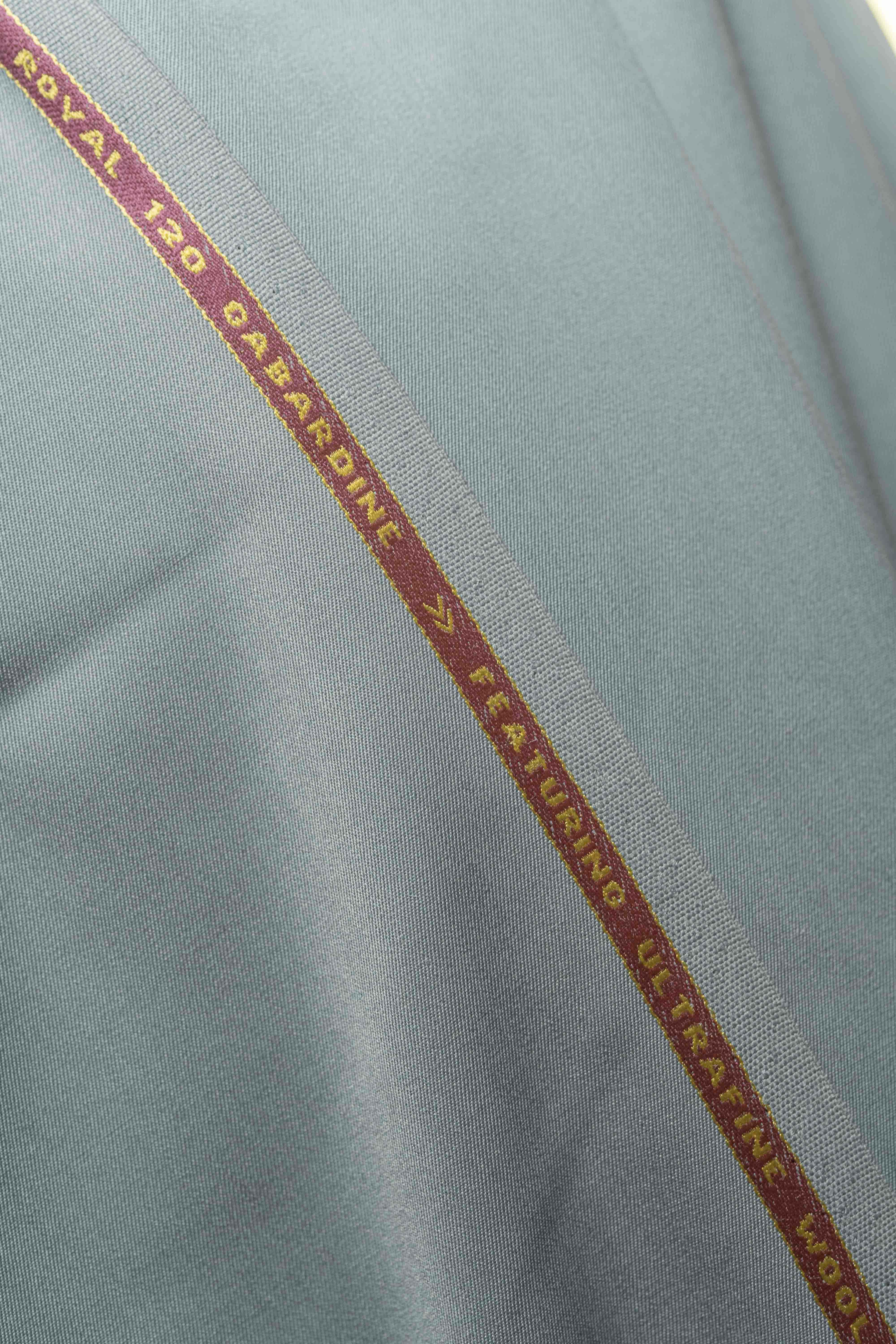 Grey 120's wool gabardine suit fabric showcasing smooth texture and quality with a focus on durability.