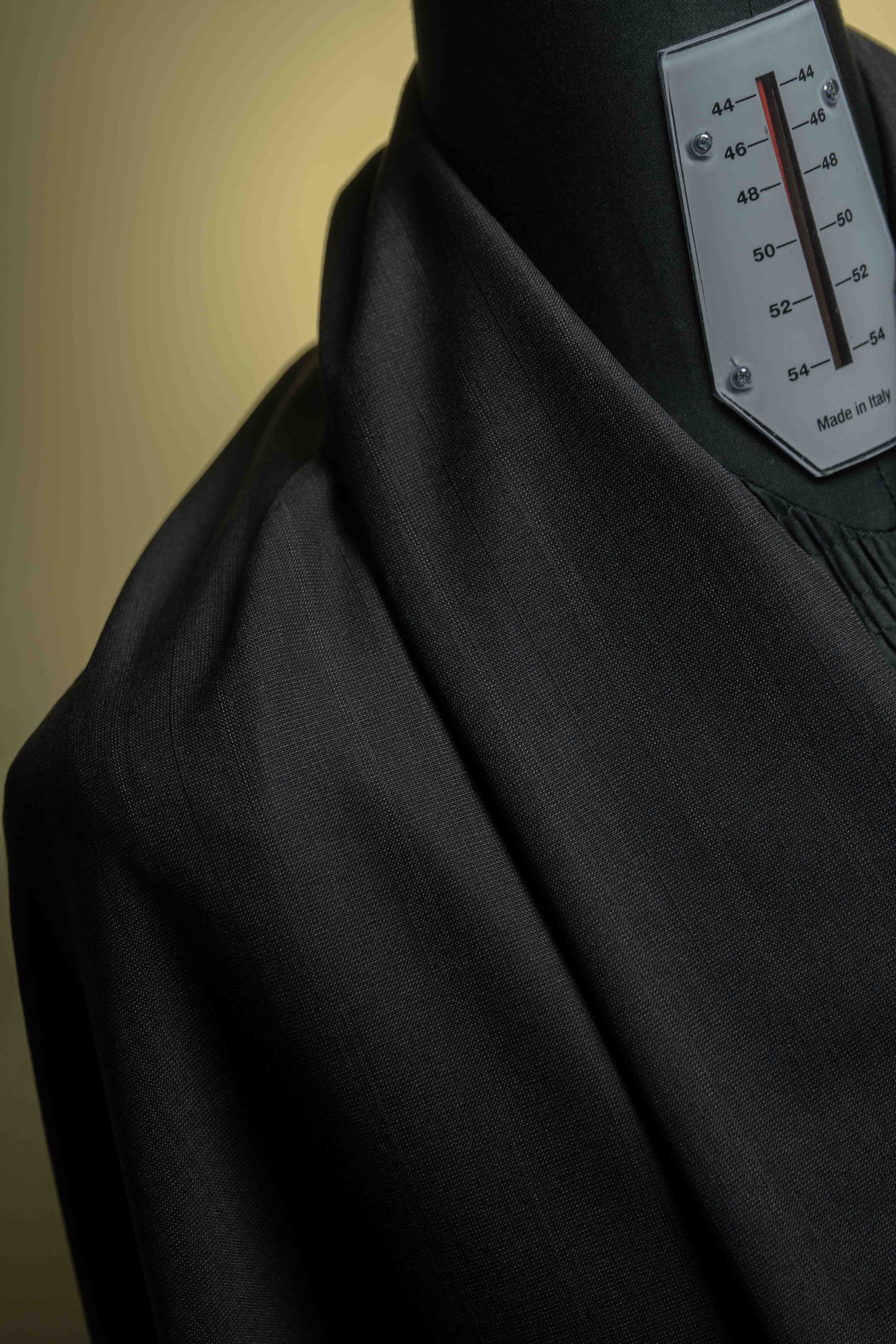 Holland & Sherry Fabric in charcoal stripe, showcasing luxurious texture on dress form for tailored suits.