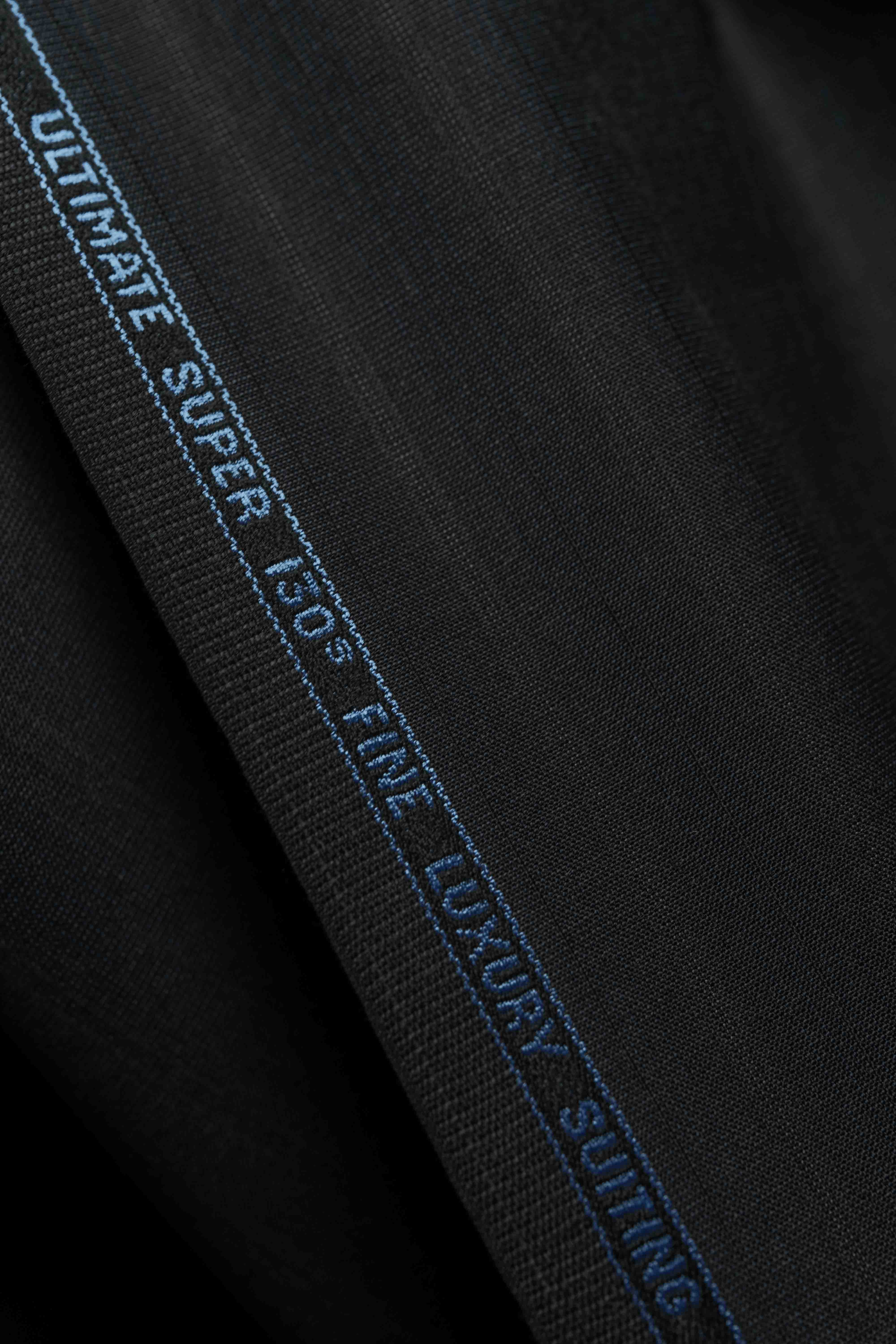 Holland & Sherry Fabric featuring a charcoal stripe design for luxury suiting, labeled Super 130's fine quality.