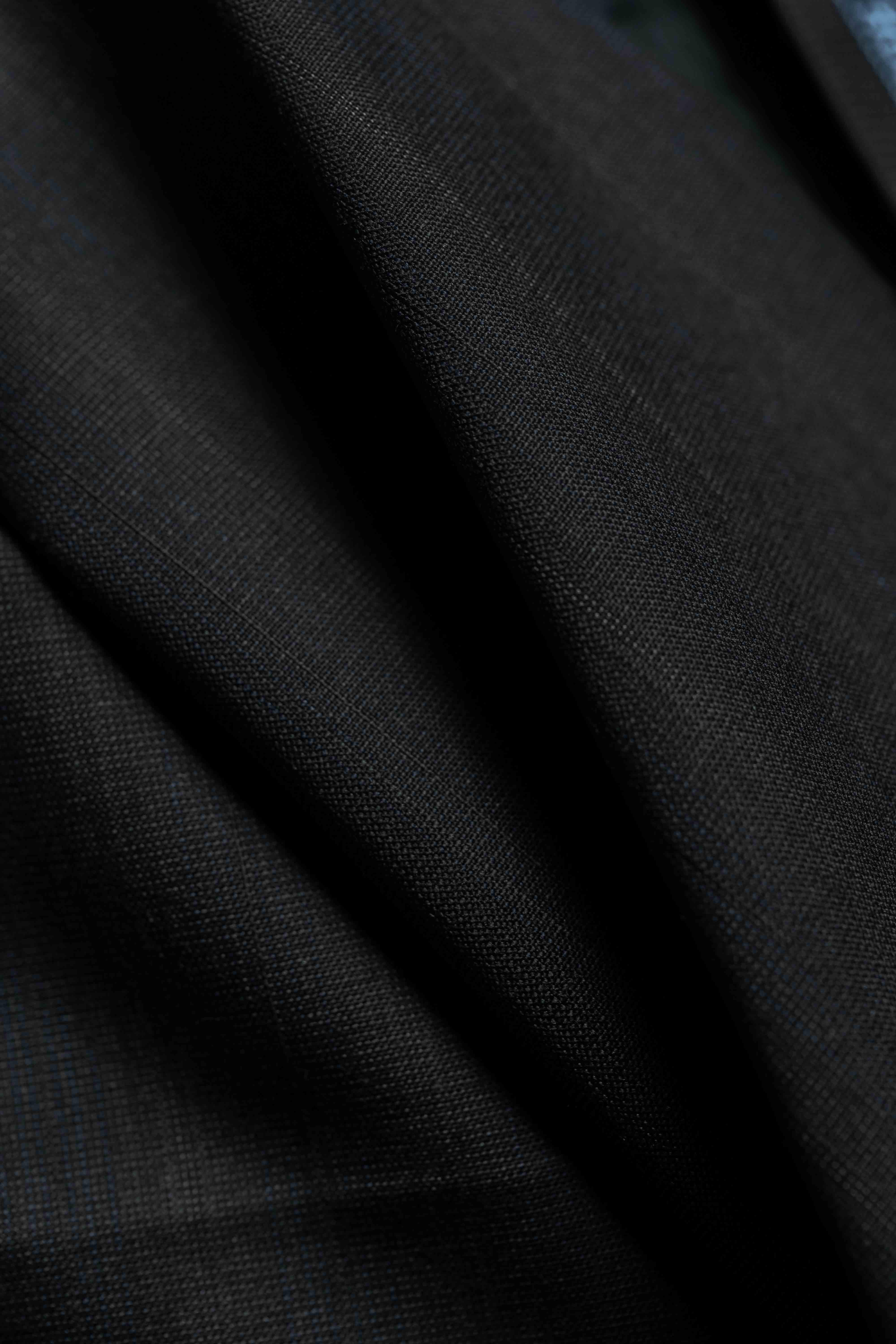 Holland & Sherry Fabric close-up showing charcoal stripe texture on high-quality 130's suiting material.
