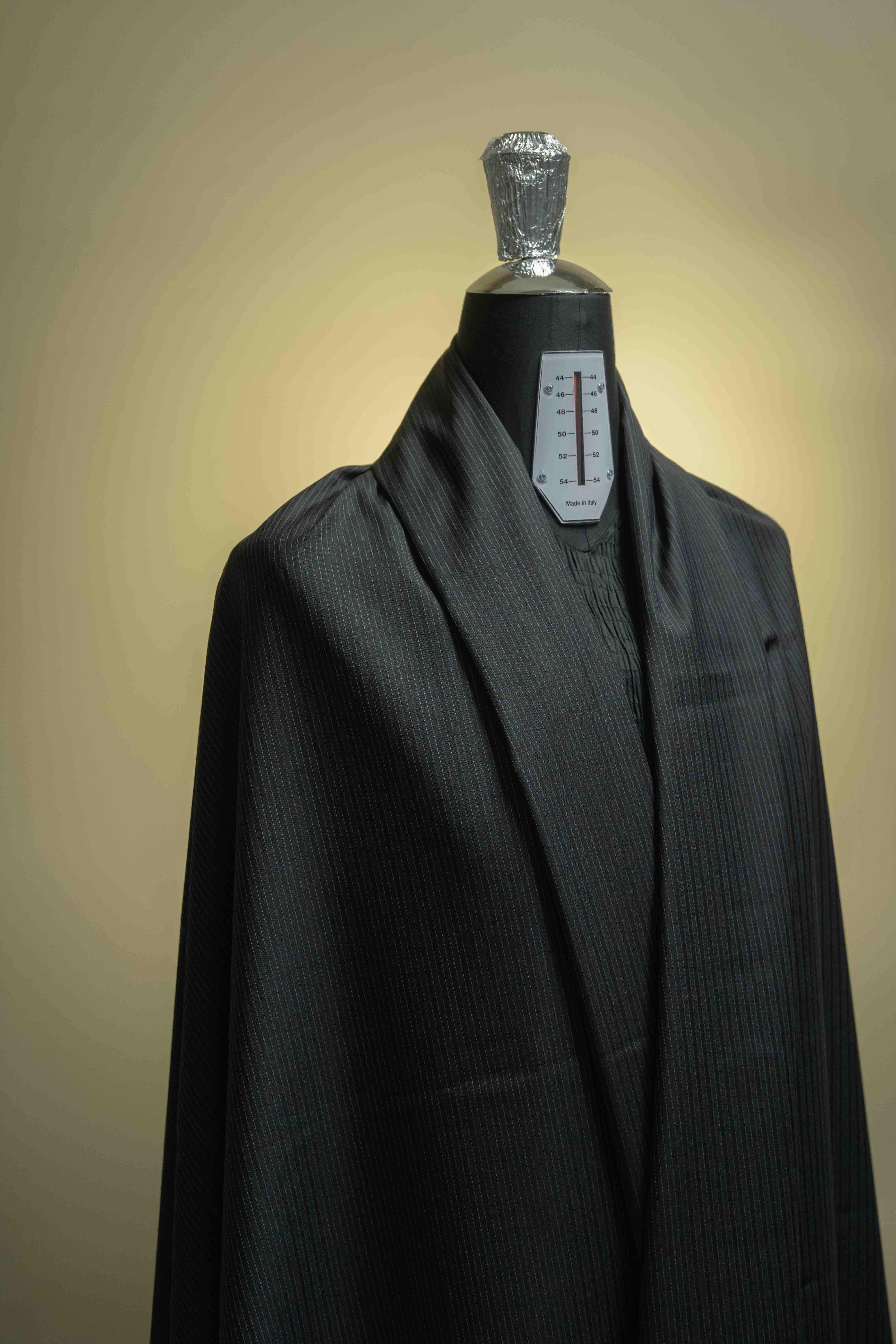 Lassiere Charcoal Blue Stripe 130's Suit fabric (V23310) displayed on a mannequin, perfect suit fabric for tailored clothing.