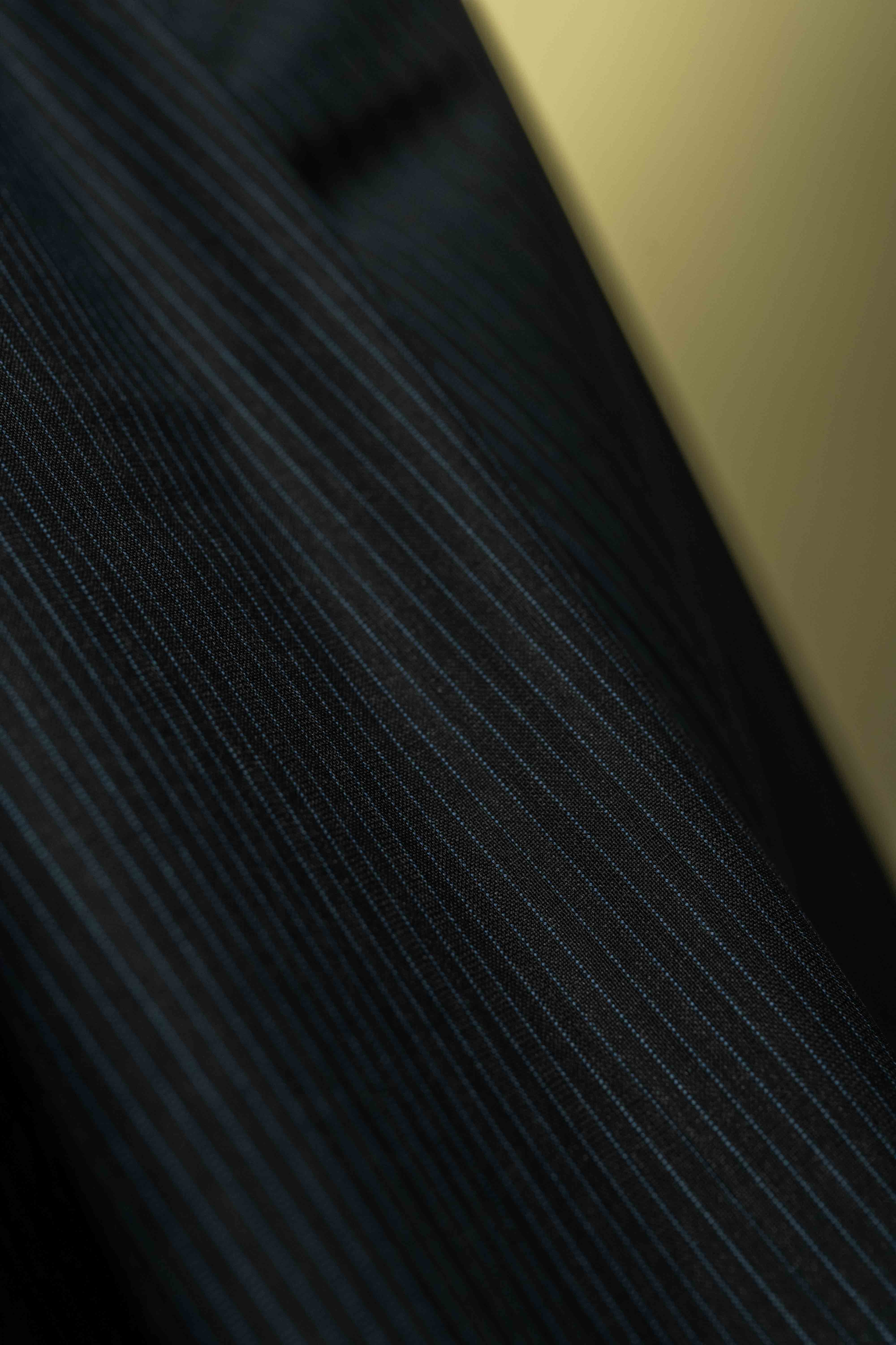 Close-up of Lassiere Charcoal Blue Stripe 130's Suit fabric (V23310) showcasing fine stripes, ideal for suit fabric.