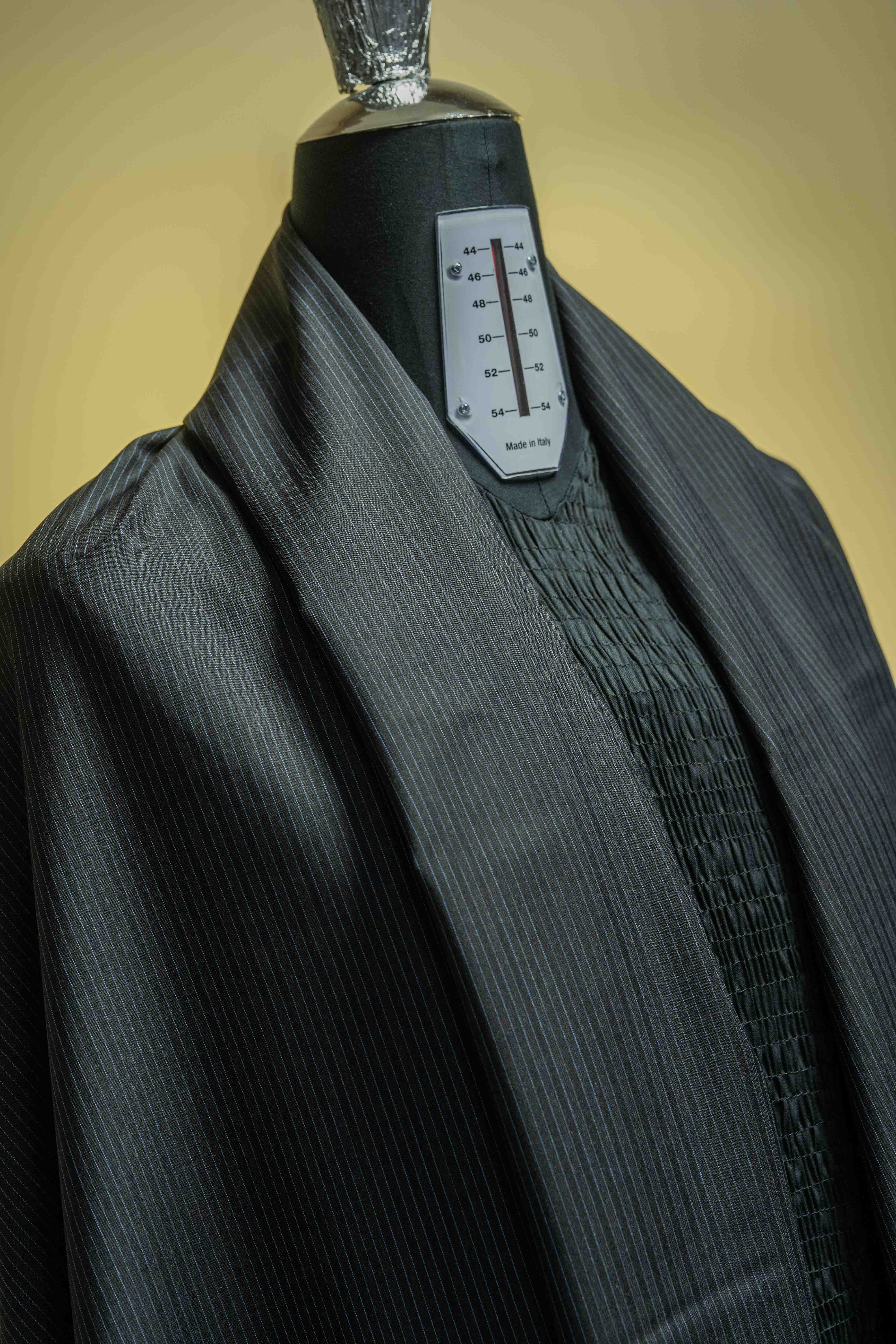Lassiere Charcoal Blue Stripe 130's Suit fabric (V23310) displayed on a mannequin, showcasing its texture and design.