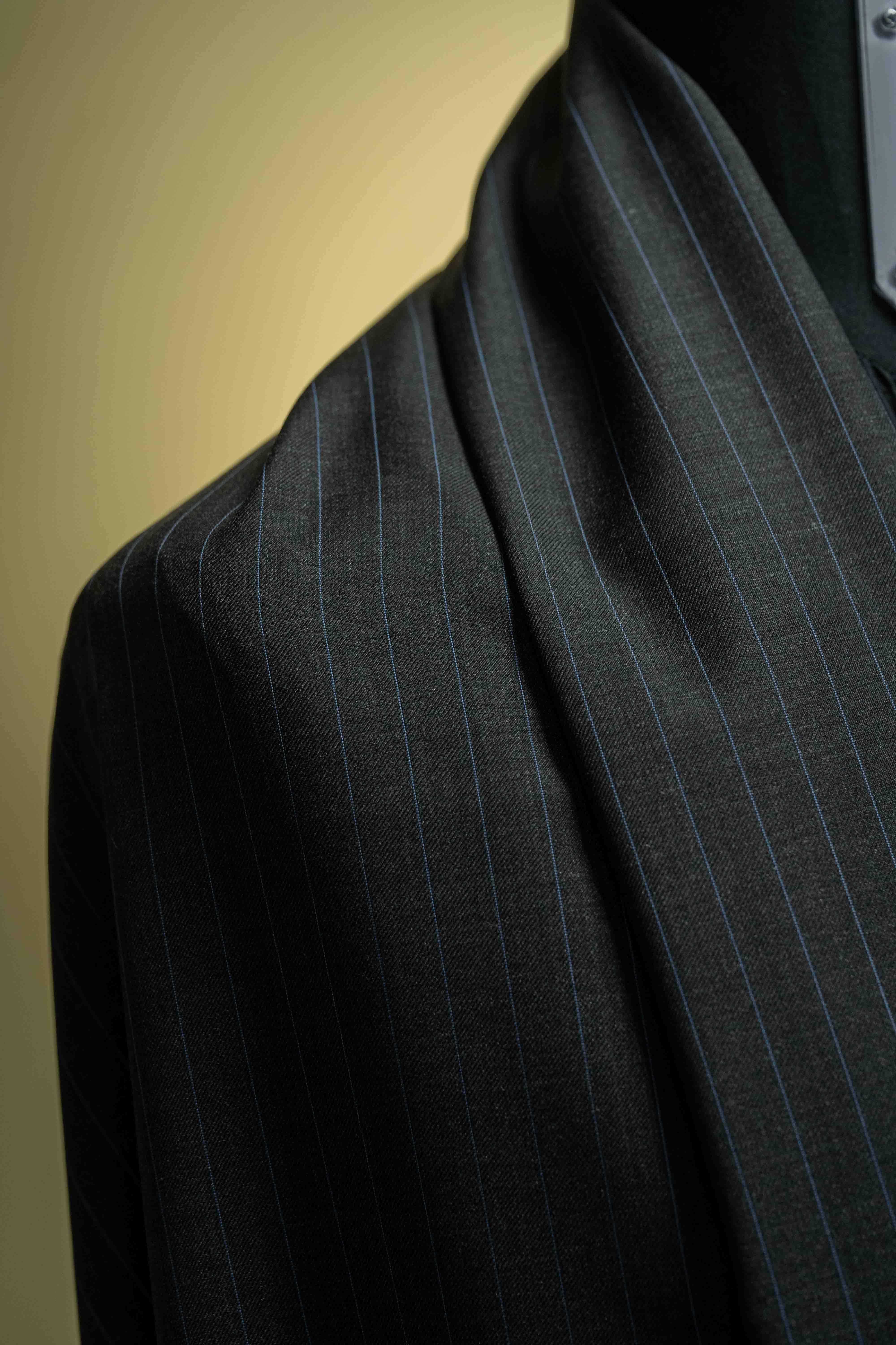Charcoal blue stripe cashmere suiting fabric showcasing fine details in elegant draping.