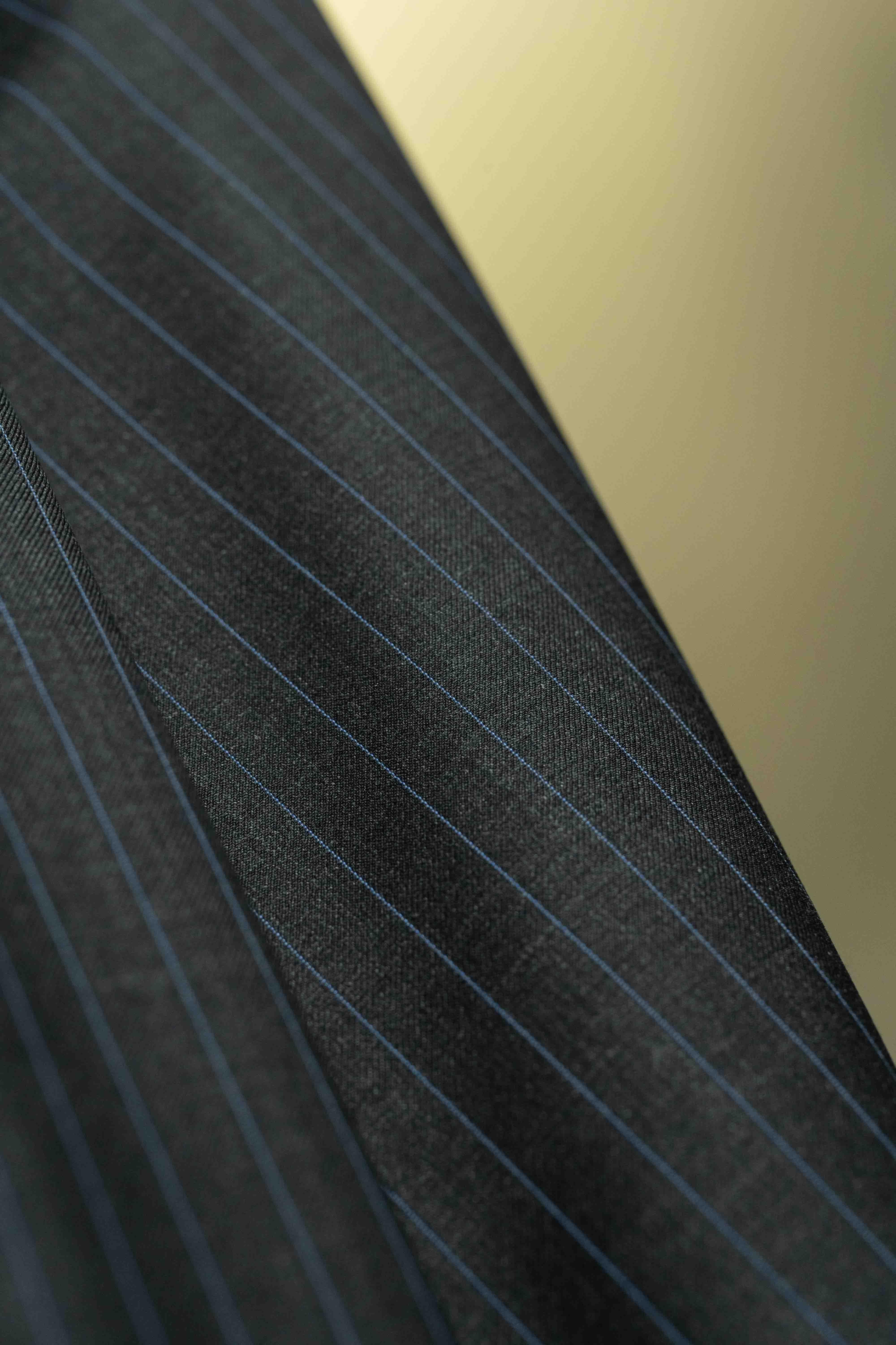 Charcoal blue stripe fabric close-up showcasing 150's & cashmere suiting quality. Ideal for sophisticated attire.