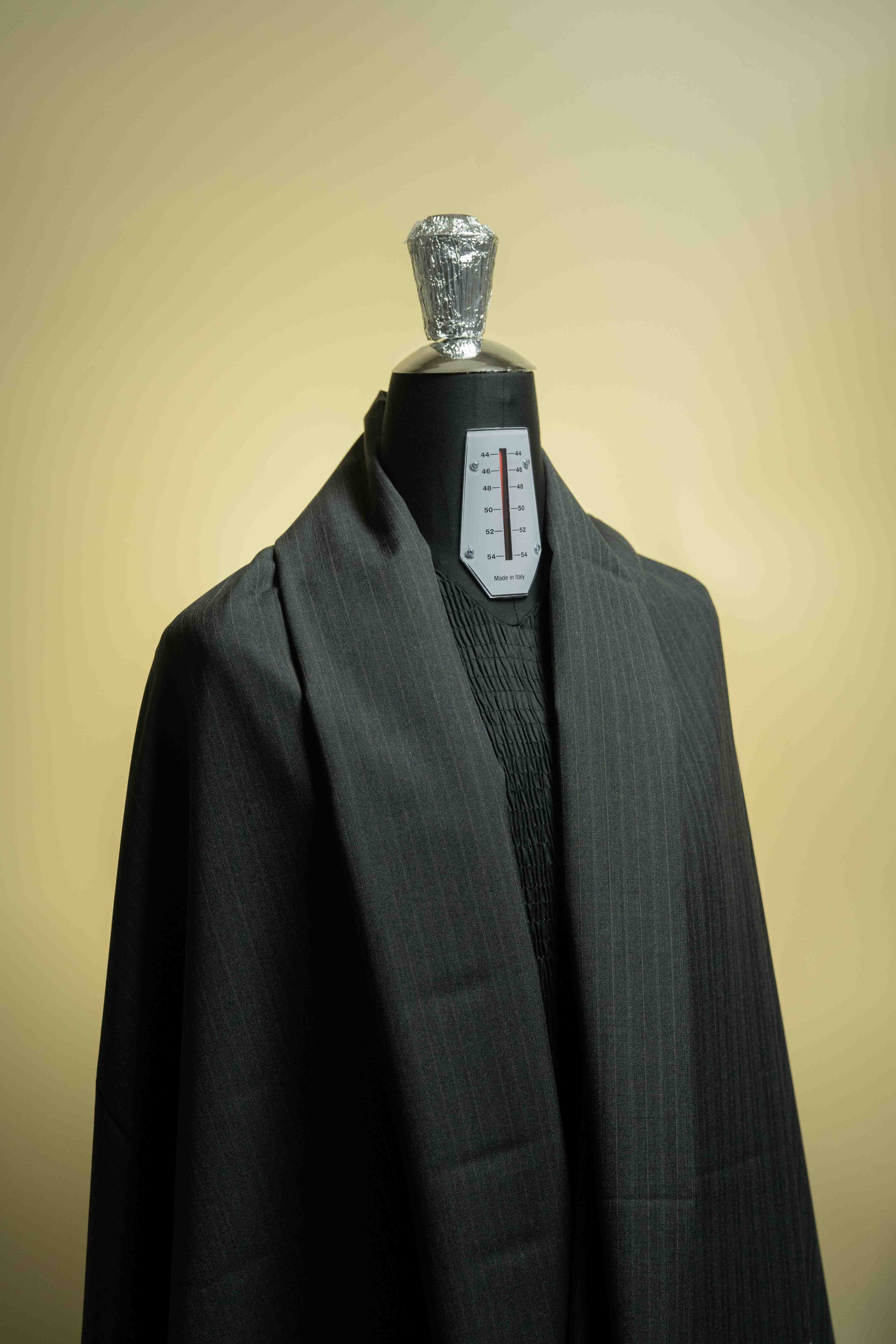 Lassitex Charcoal Stripe Merino Wool Suit Fabric (V23385) showcased on a dress form as high-quality suit fabric.