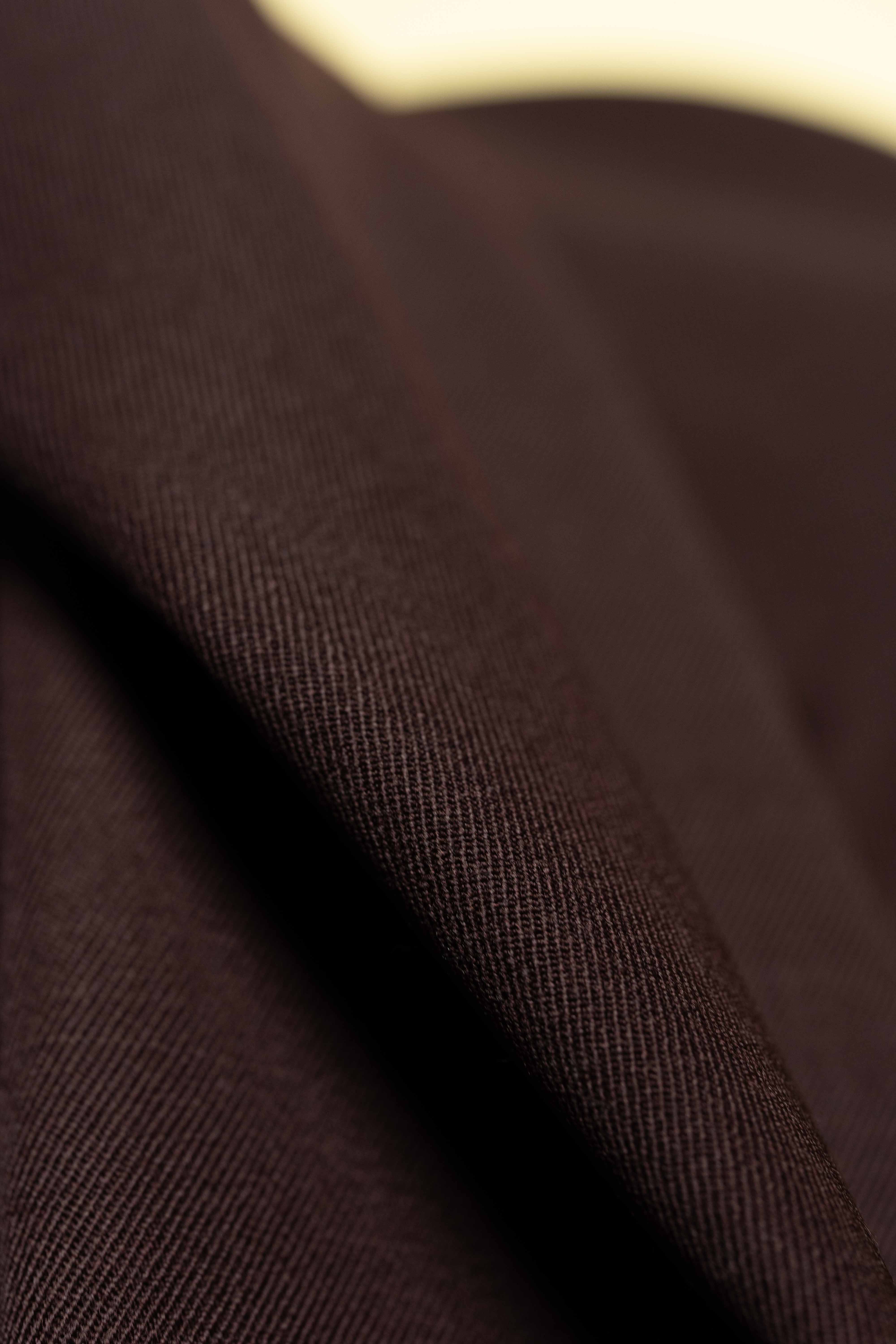 Close-up of luxurious red minkcash suit fabric showcasing its fine texture and quality.