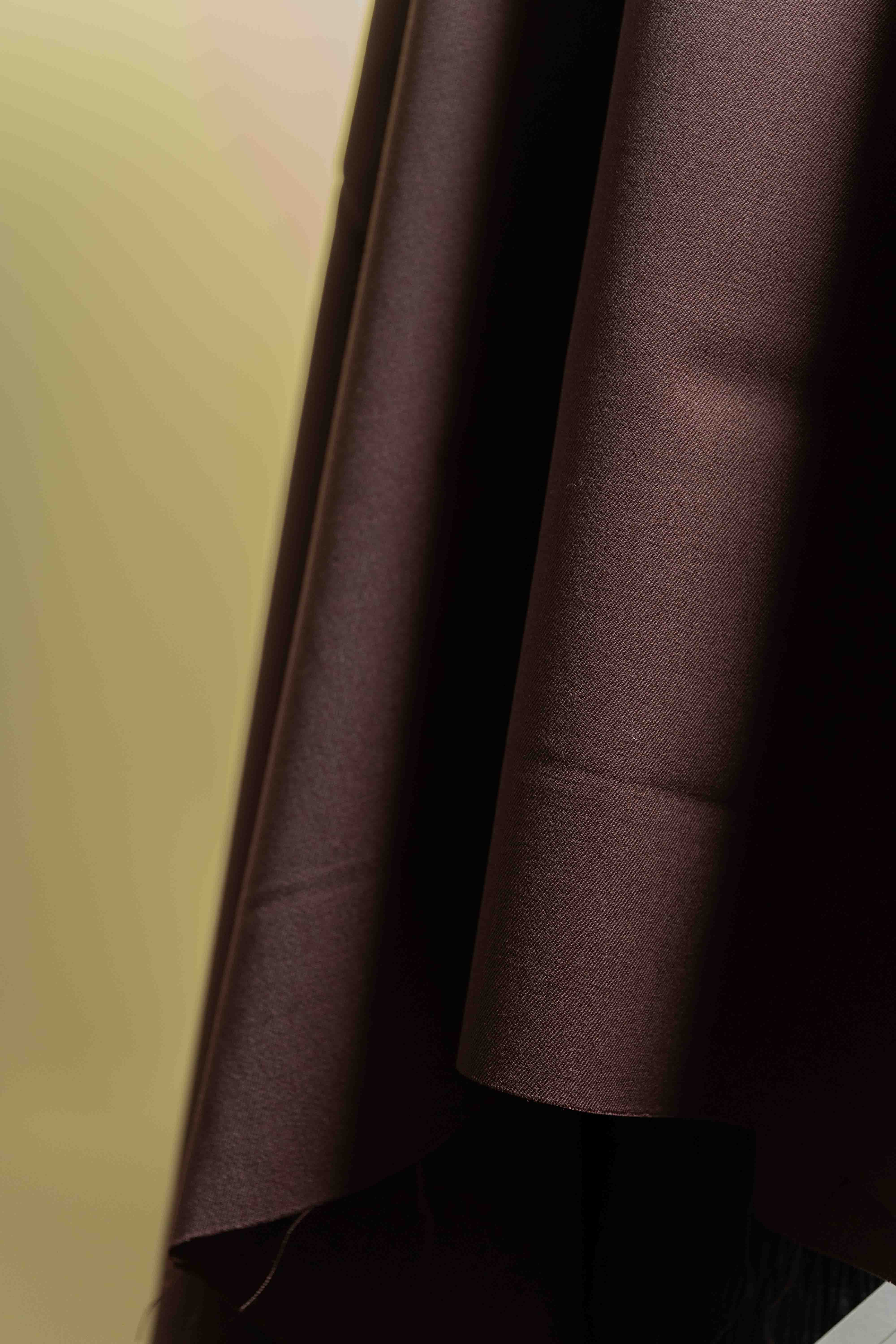 Red minkcash suit fabric draped elegantly, showcasing the fine texture of 90's worsted gabardine.