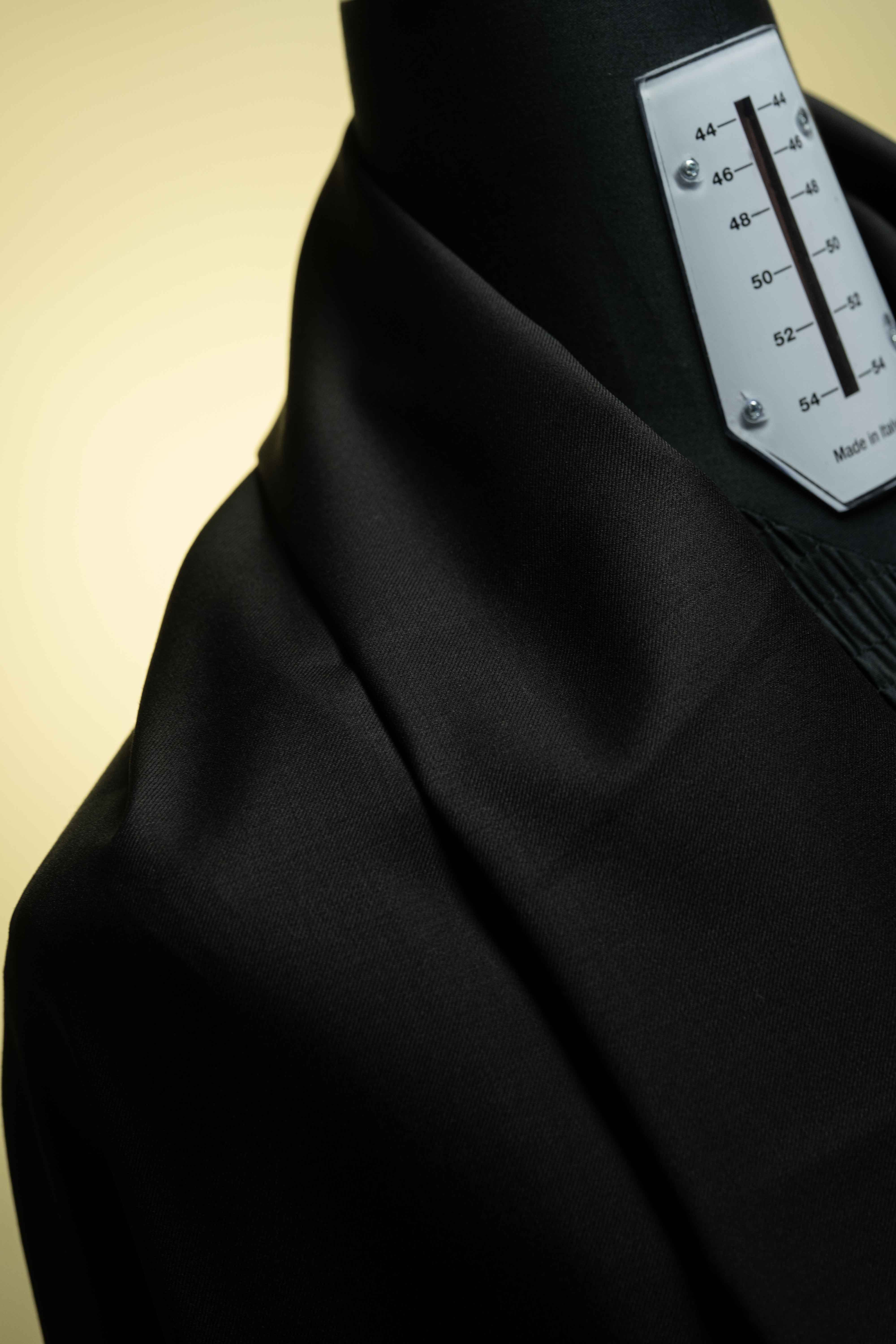 Black Merino Cashmere Wool with Silk Suit Jacket fabric close-up showcasing luxurious texture and style. Focus on Cashmere.