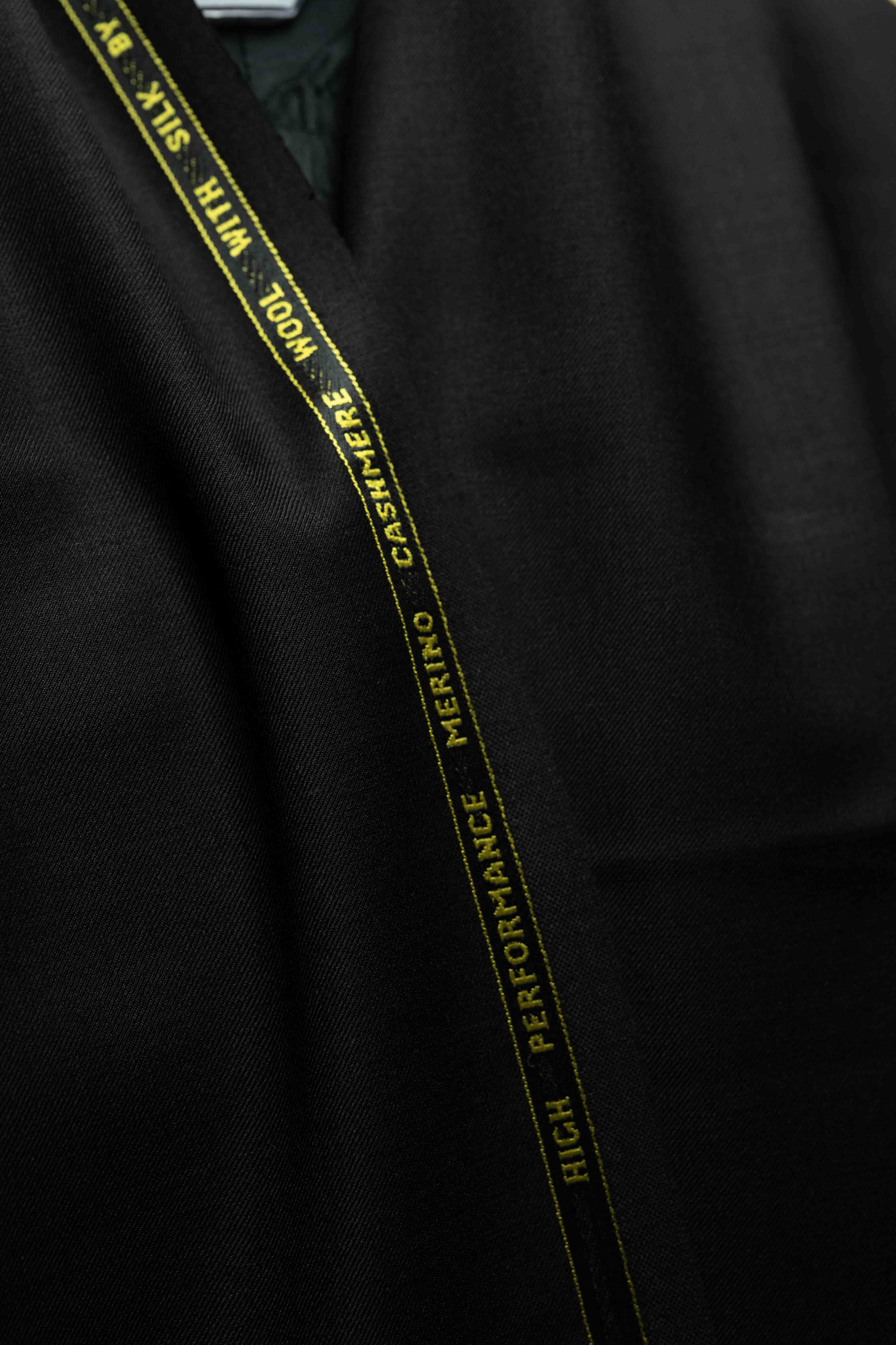 Close-up of Black Merino Cashmere Wool with Silk Suit Jacket highlighting the cashmere label.