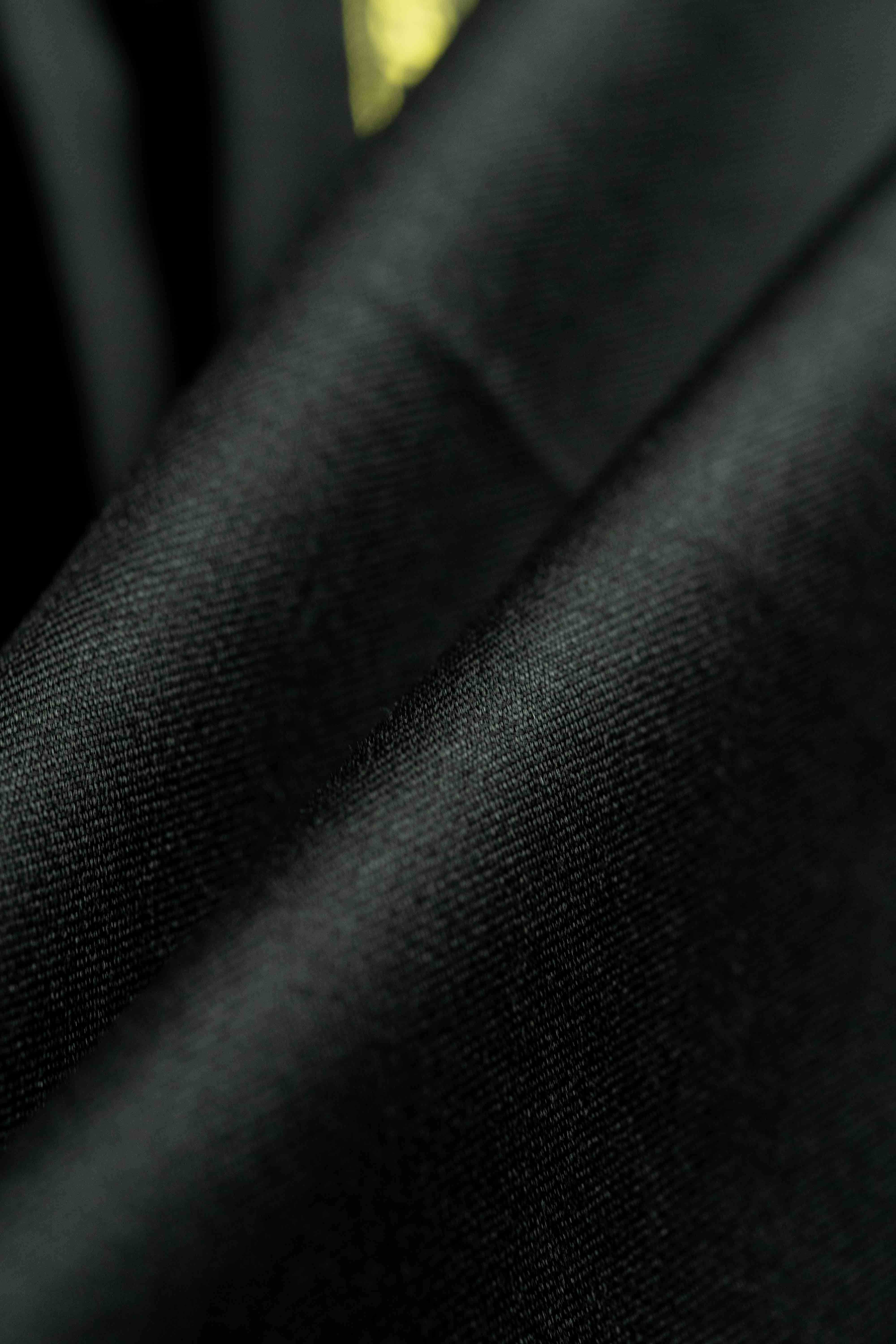 Close-up of luxurious black fabric showcasing the texture of Black Merino Cashmere Wool with Silk Suit Jacket.