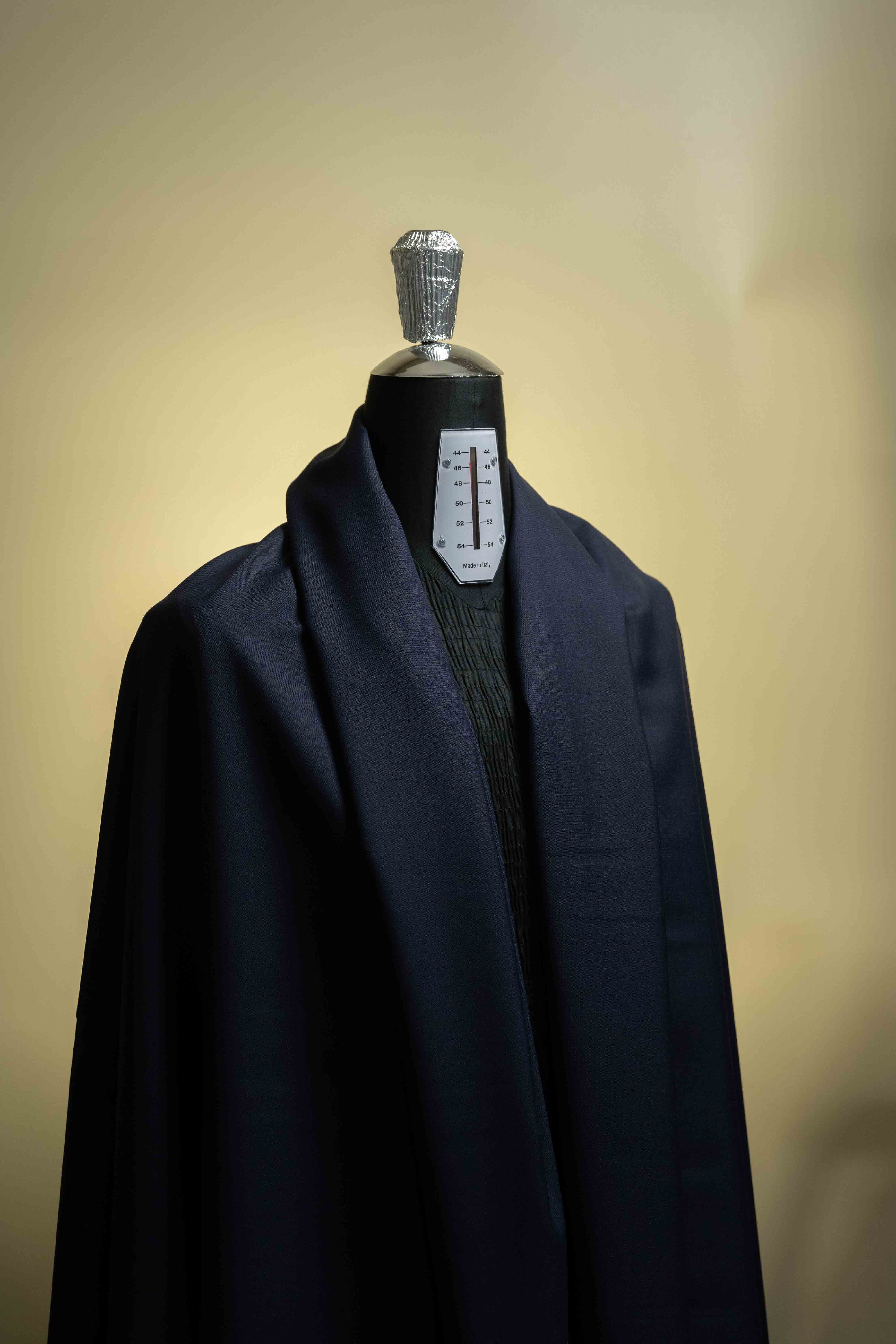 Navy Suiting in Super 100's Wool & Cashmere fabric draped on a mannequin showcasing high-quality textile.