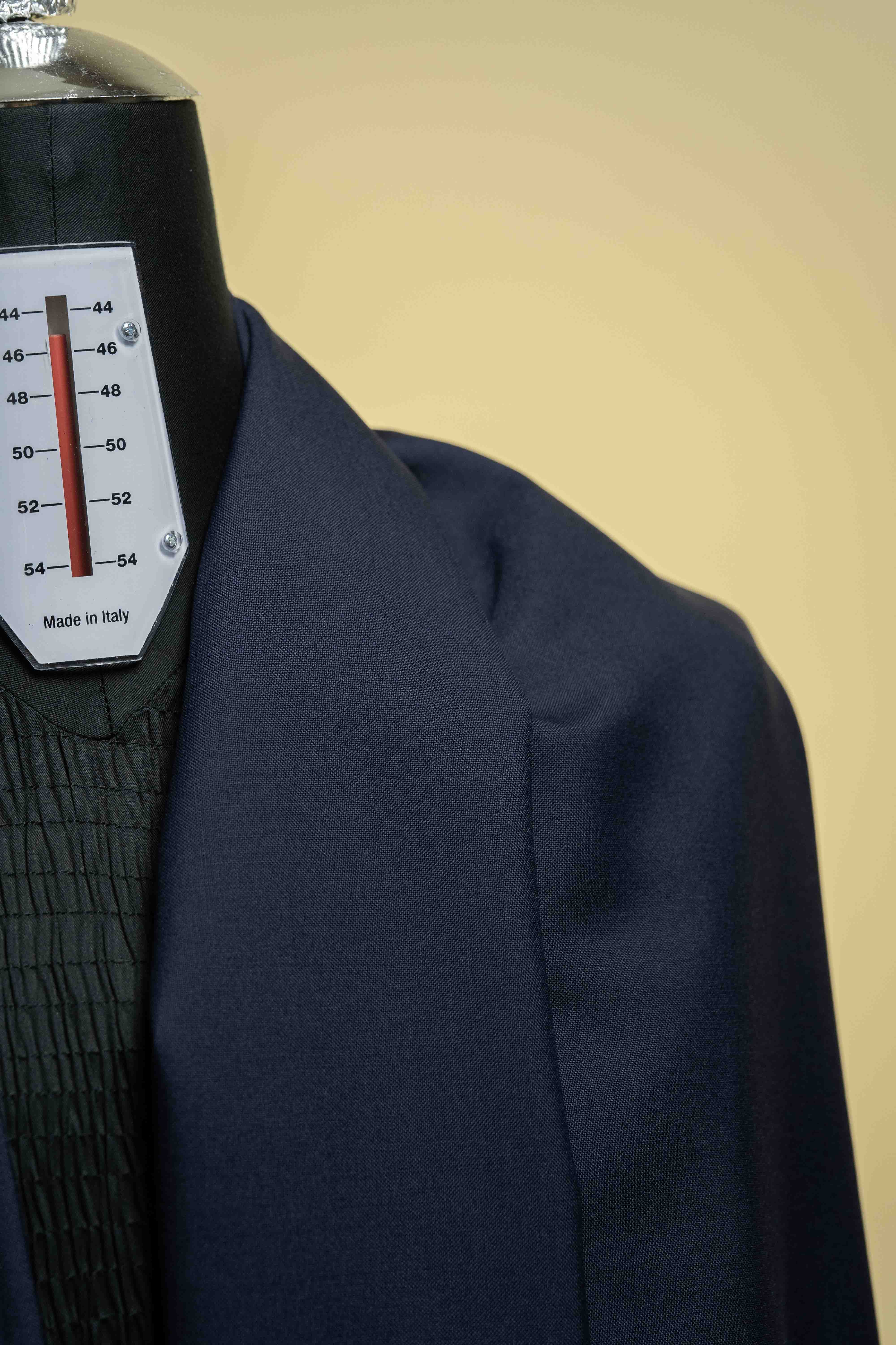 Close-up of Navy Suiting fabric in Super 100's Wool & Cashmere on a tailoring mannequin.