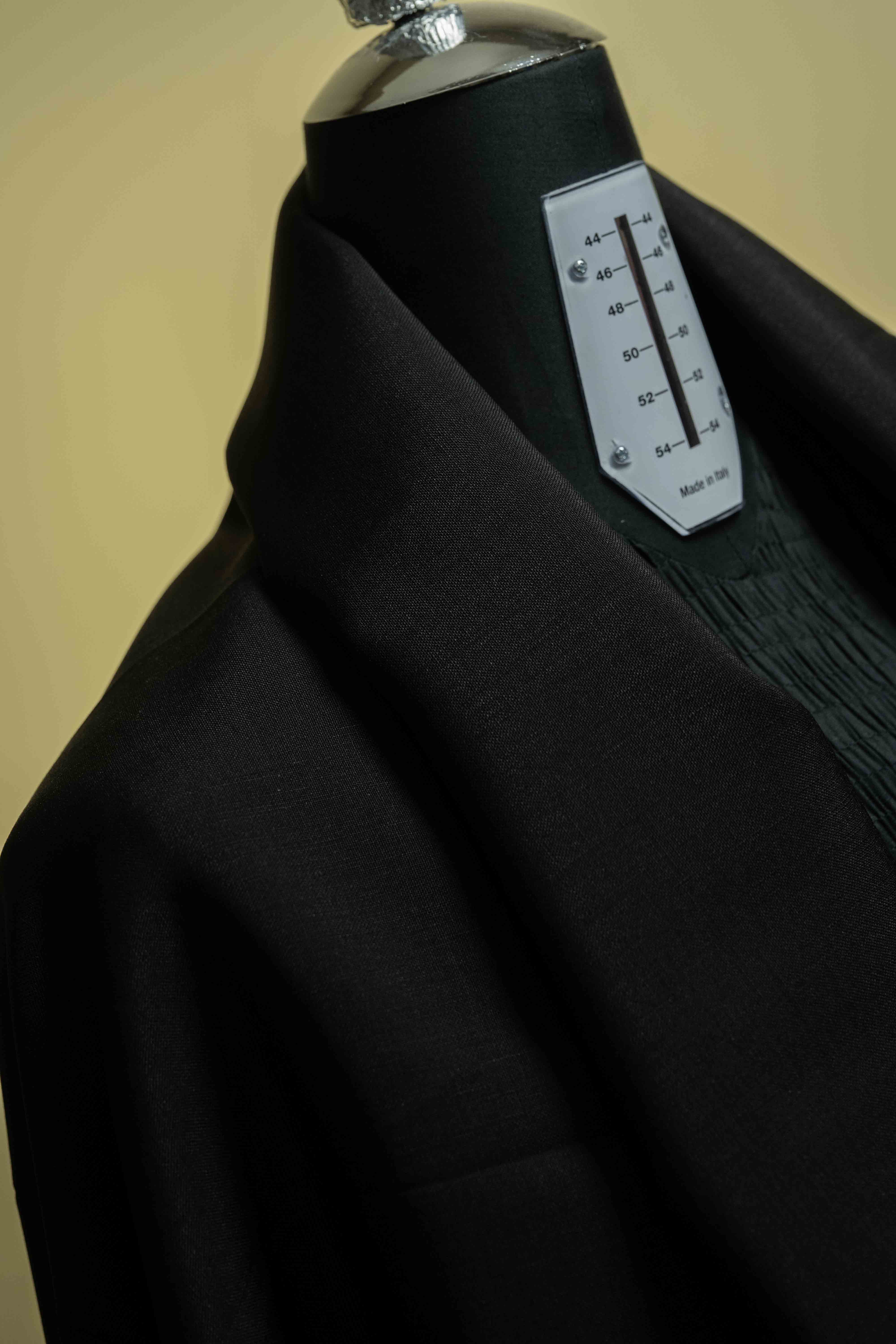 Suit fabric in black wool mohair on a mannequin for trousers, showcasing quality textile design.