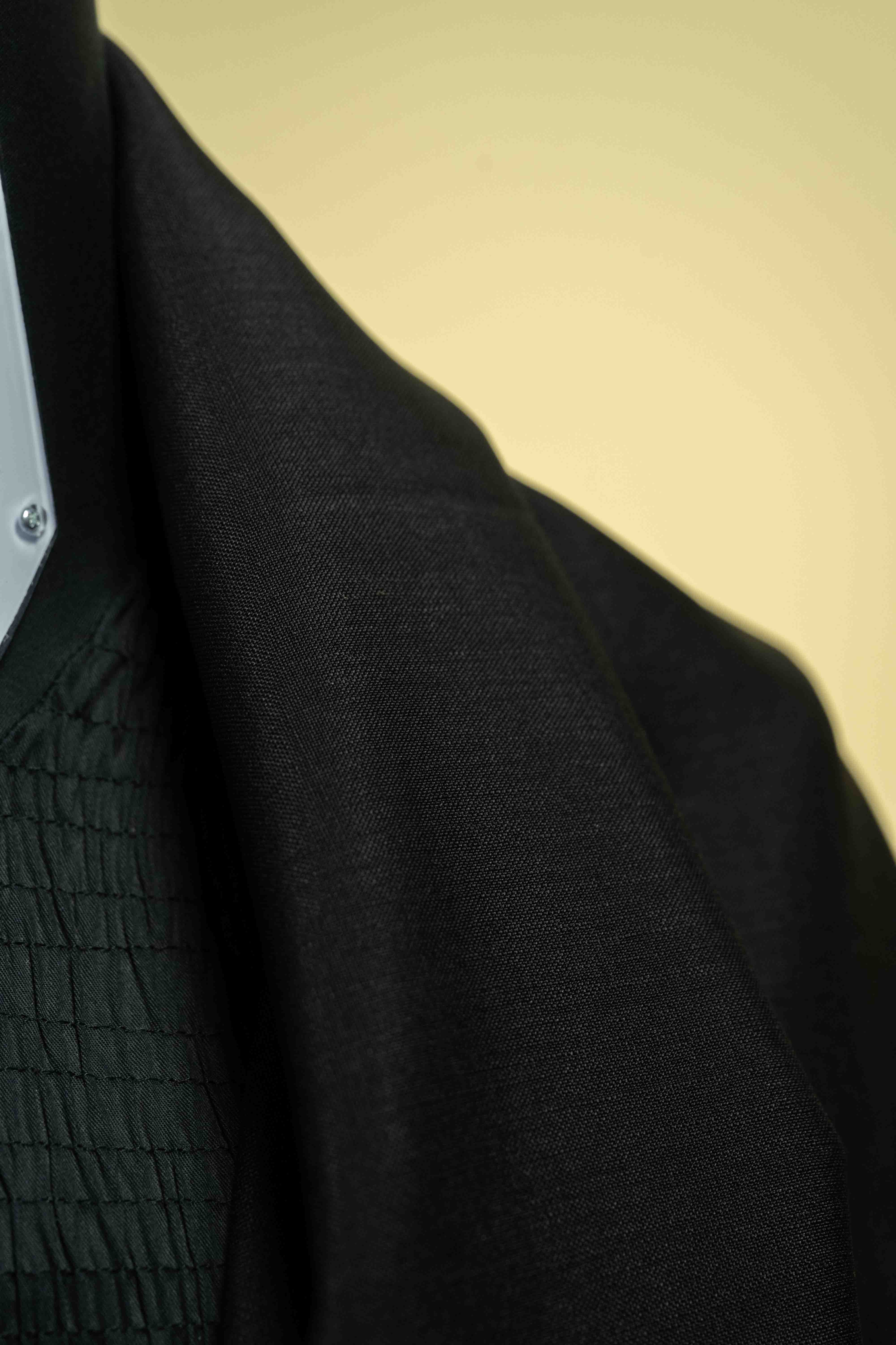 Close-up of black wool mohair suit fabric, perfect for trousers, showcasing its texture and quality - Suit fabric in Black Wool Mohair.