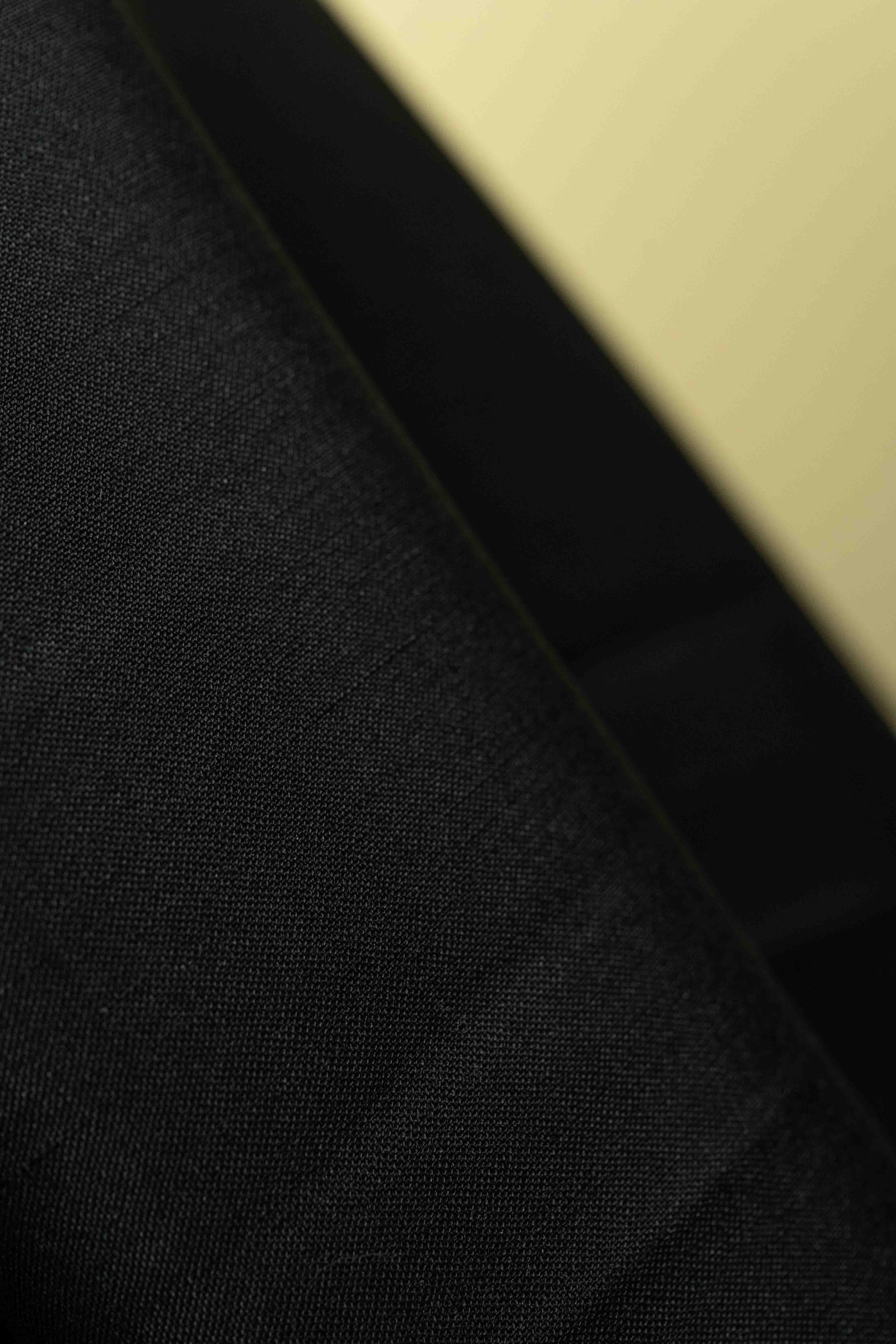 Close-up of black wool mohair suit fabric for trousers, ideal for creating high-quality suit fabric.