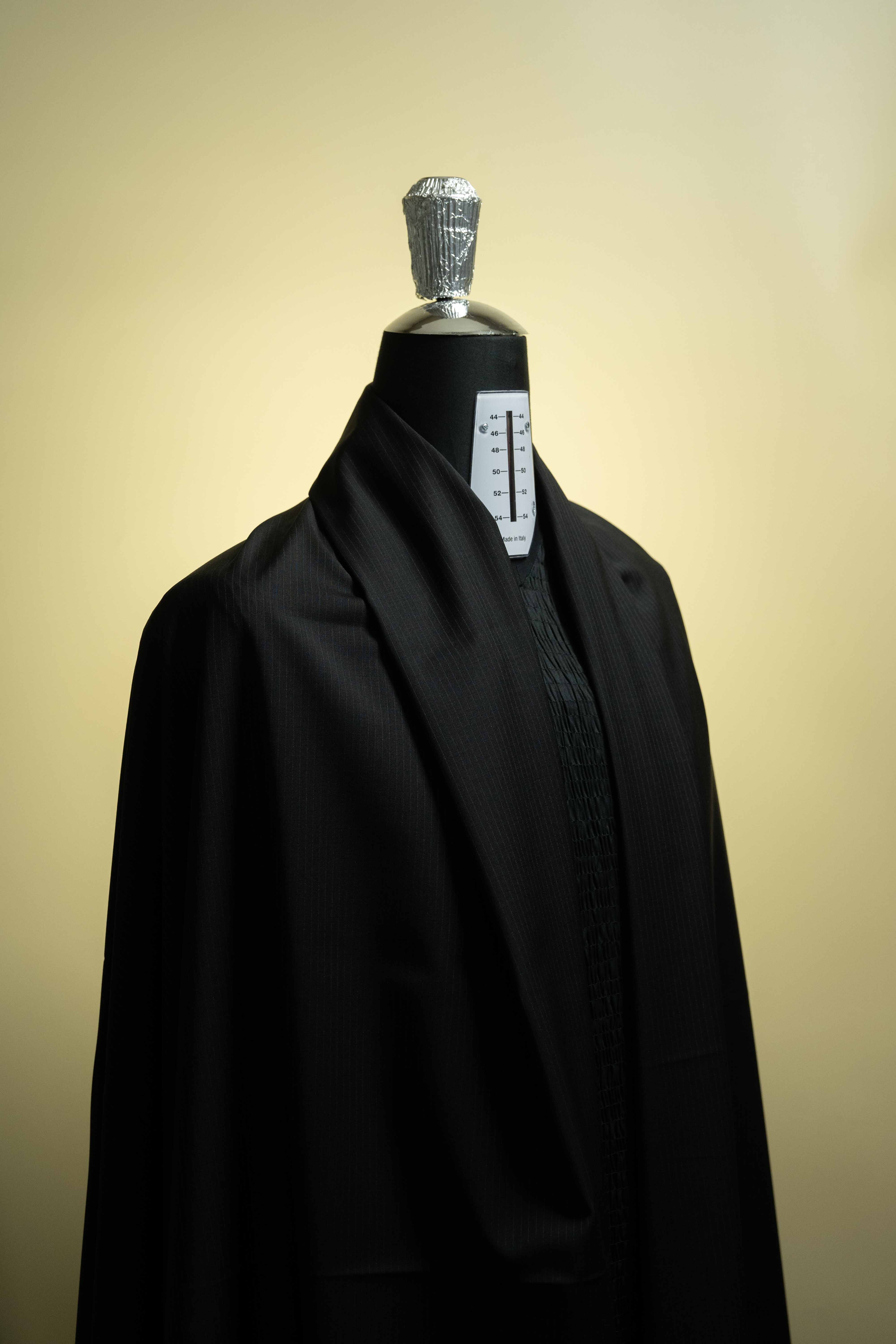 Reda Black Stripe Merino Wool Suit Fabric (V23334) displayed on a mannequin, showcasing its elegant texture and style.