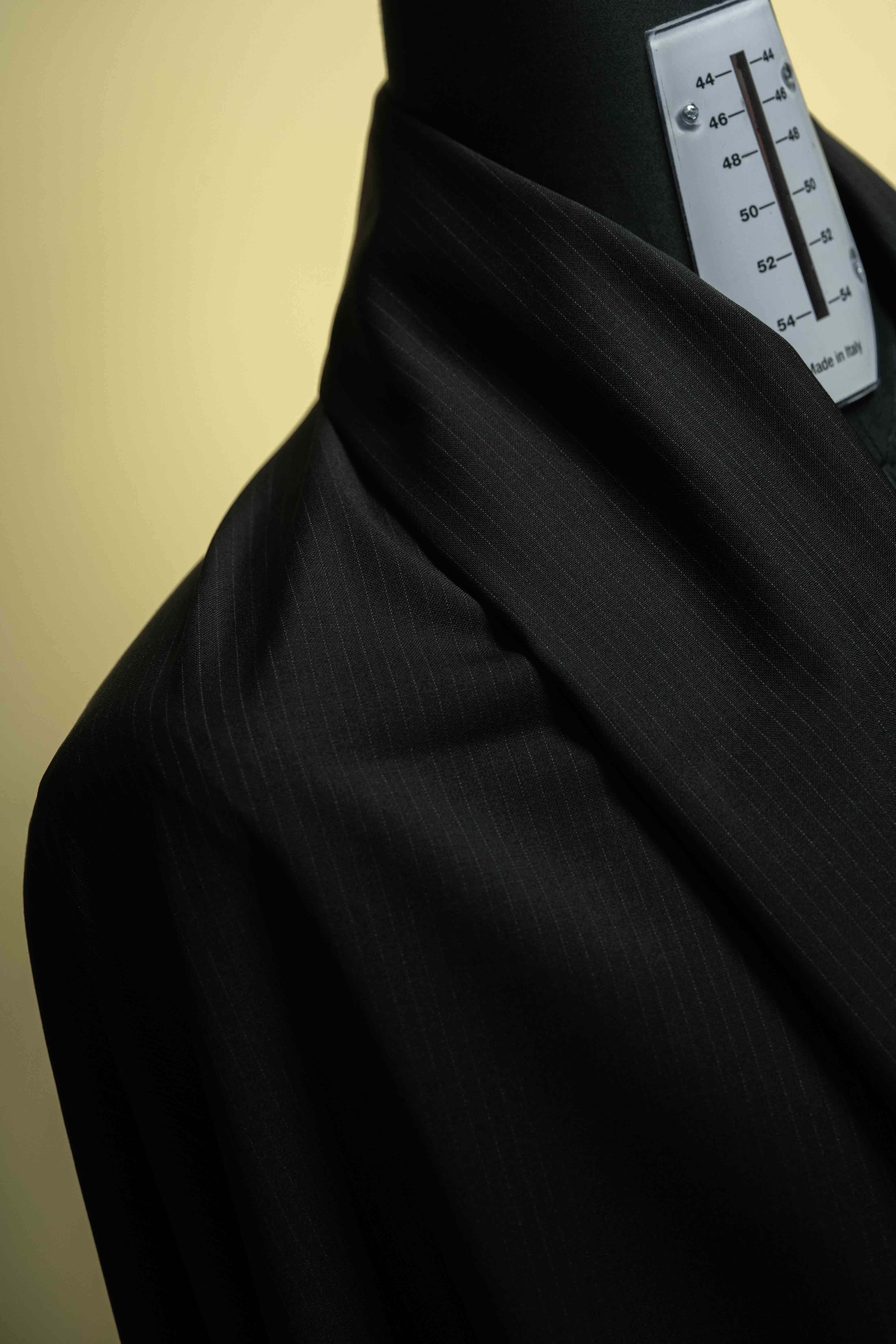 Reda Black Stripe Merino Wool Suit Fabric V23334 close-up on dress form, showcasing fine texture and elegance.