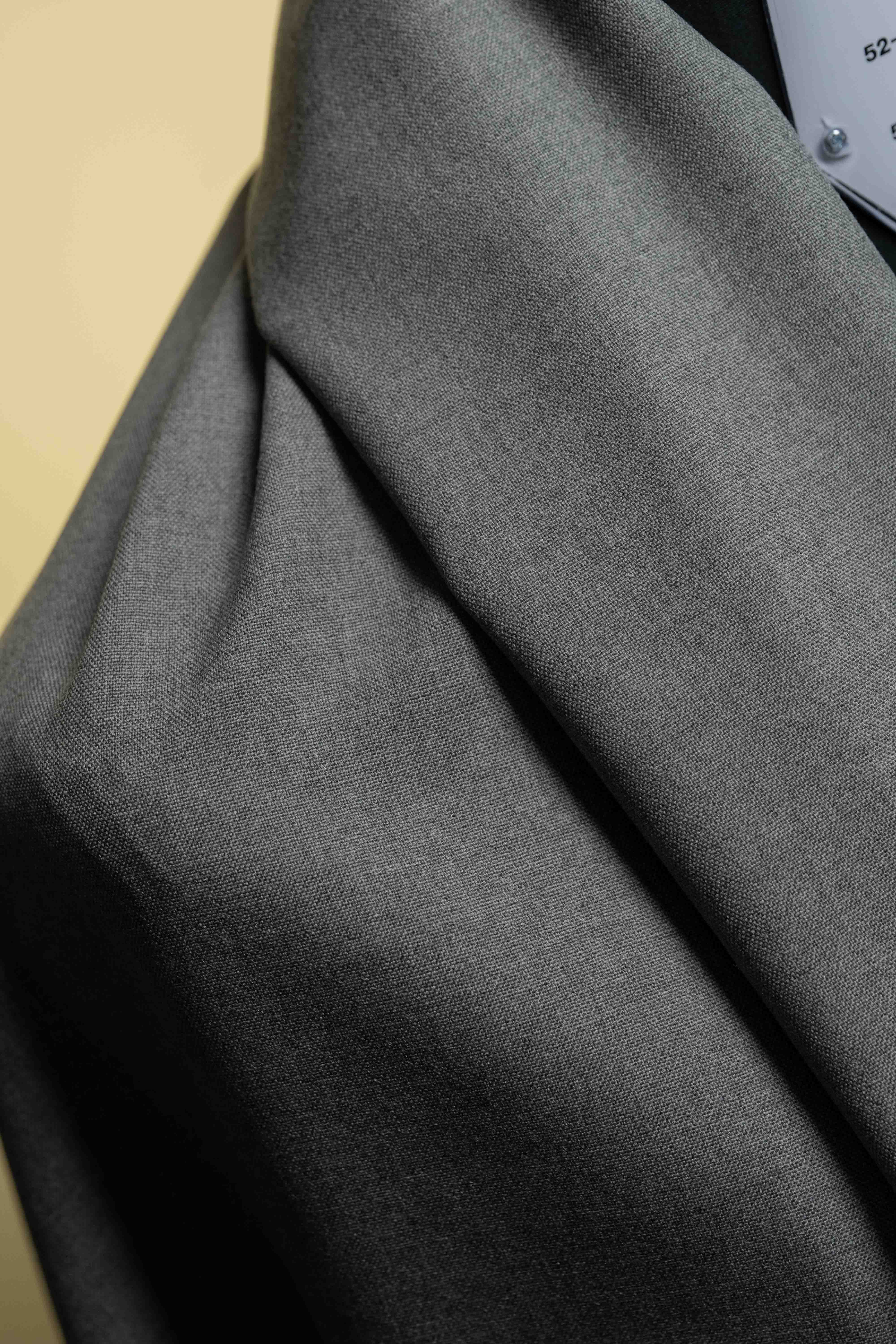 Close-up of gray fabric with a beige background