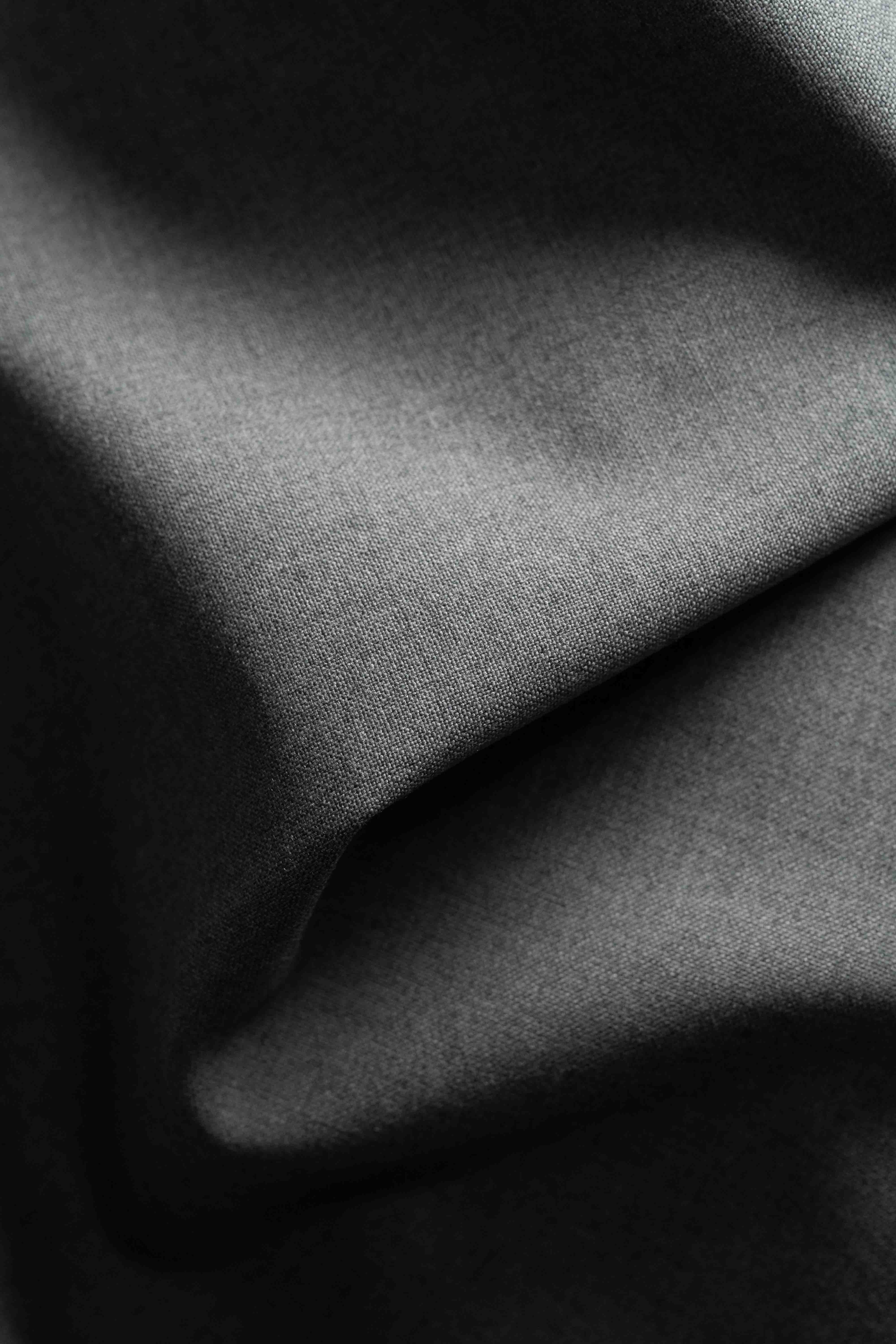 Close-up of dark gray fabric with folds