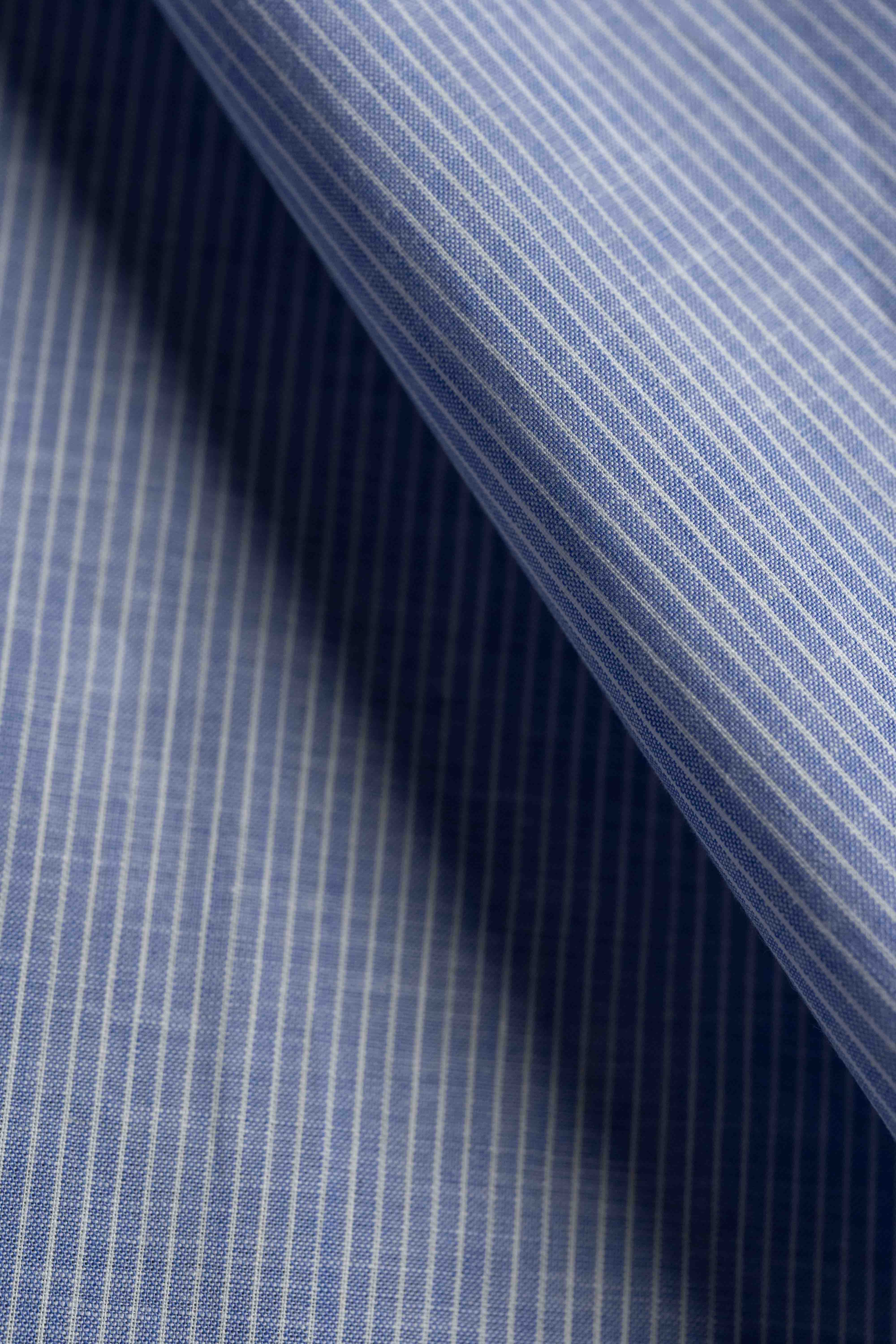 Close-up of blue striped fabric with a diagonal pattern