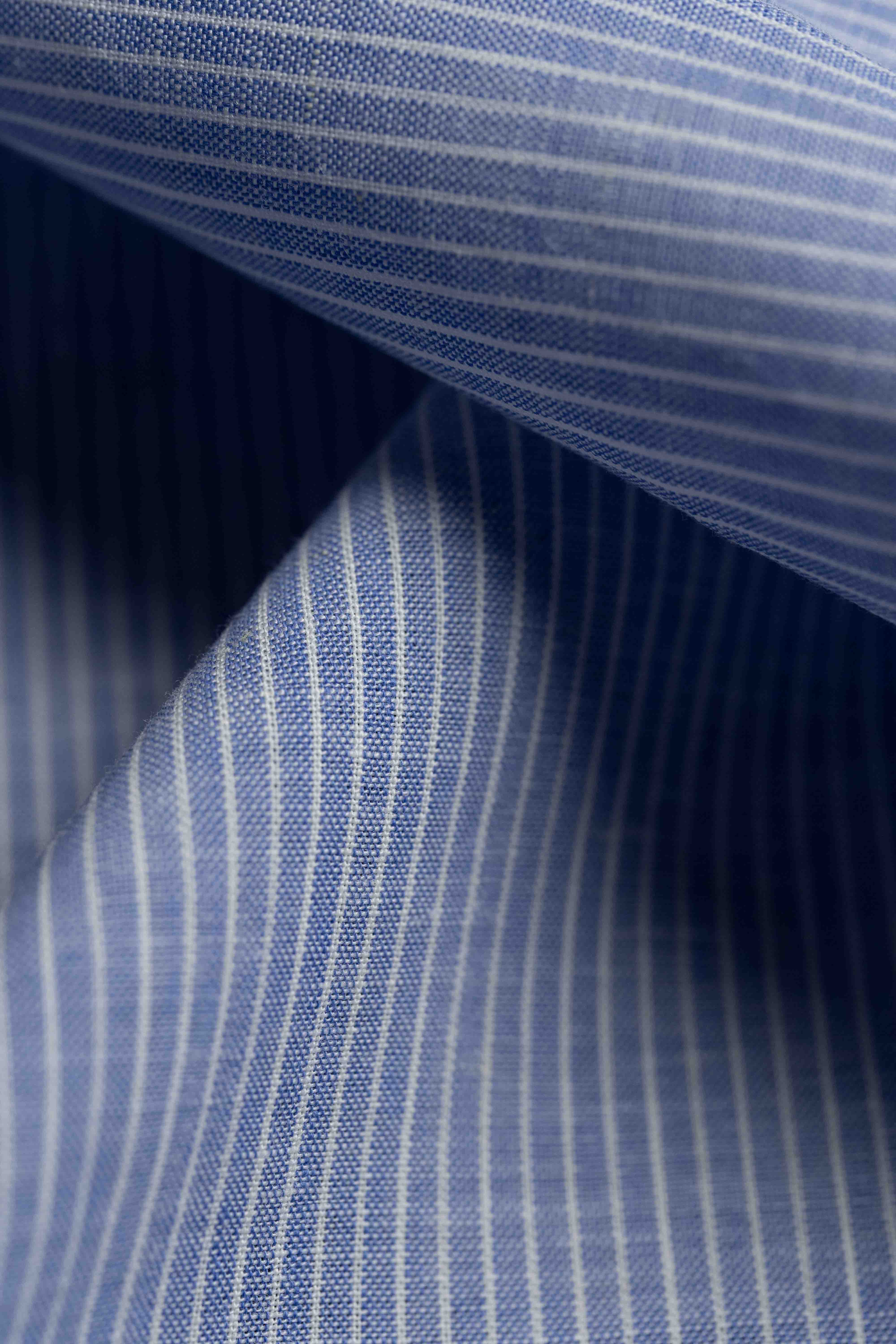 Close-up of blue striped fabric with a focus on texture and pattern.