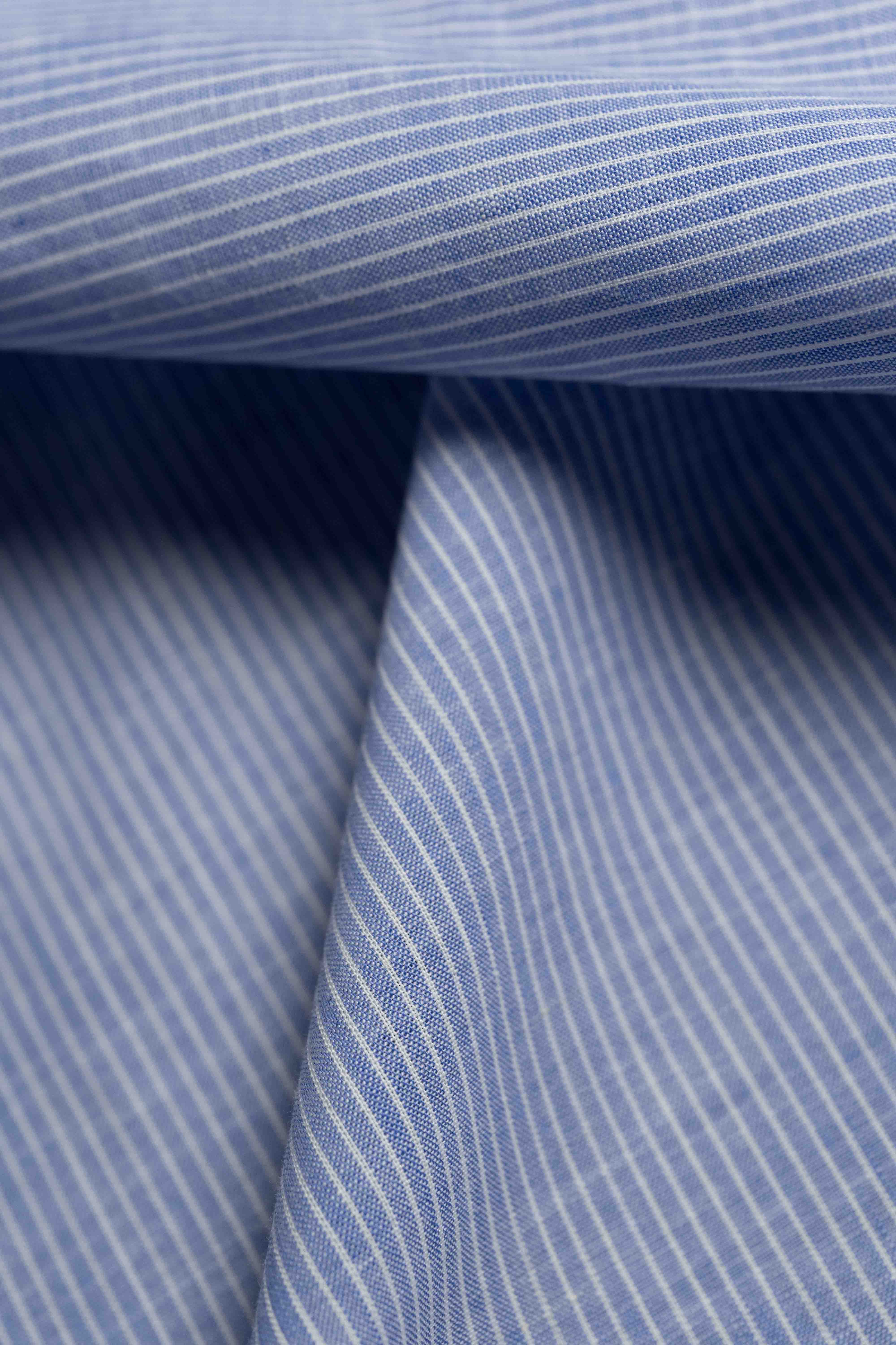 Close-up of blue striped fabric with a focus on texture and pattern.