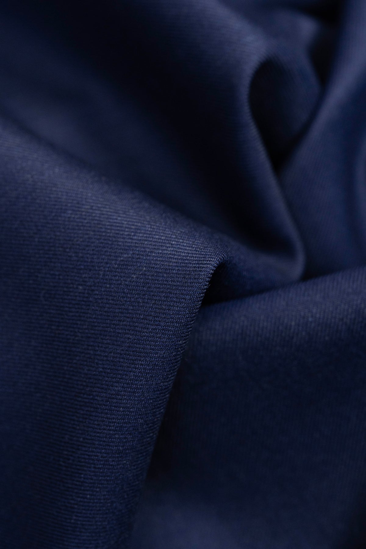 Close-up of Giovanni Tonella Blue Super 120's Wool Suiting Fabric showcasing rich texture and navy color.