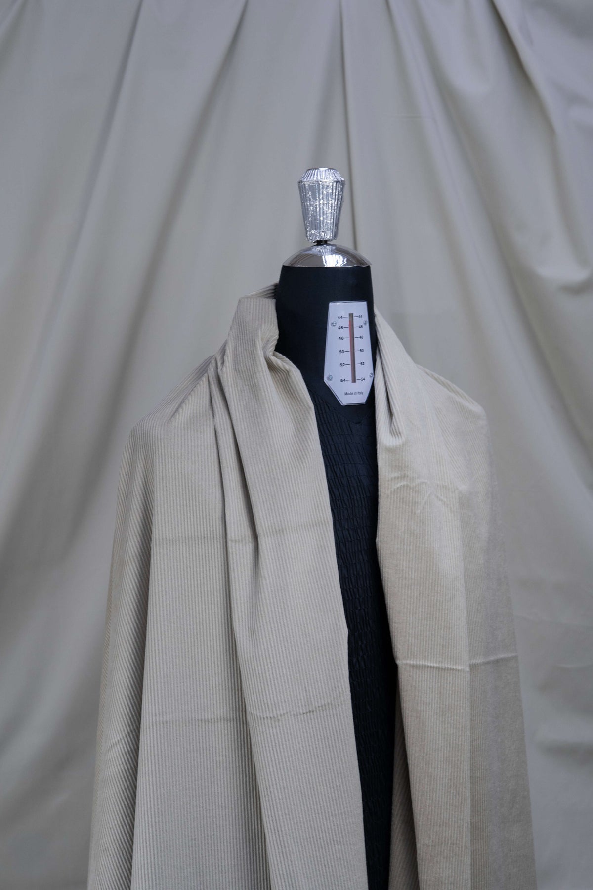 PONTOGLIO 1883 cotton cashmere corduroy suiting fabric displayed on a dress form, showcasing its texture and color.